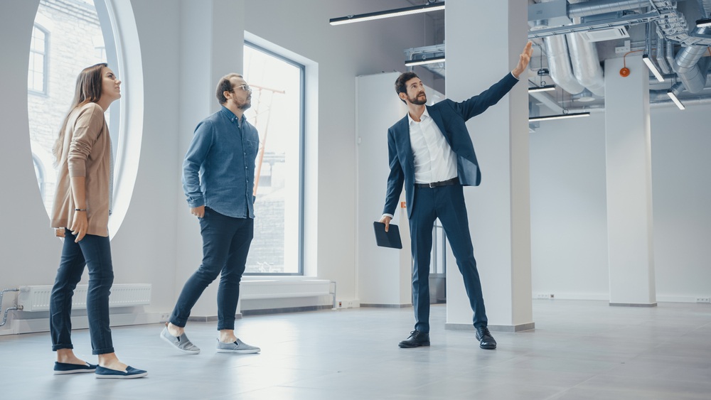 Realtor Showing Two People Office Space